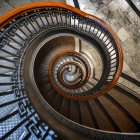 Graceful spiral staircase against golden sunset and clouds