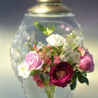 Glass terrarium with pink and white roses on gradient background