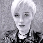 Monochrome portrait of person in leather jacket with choker on textured background