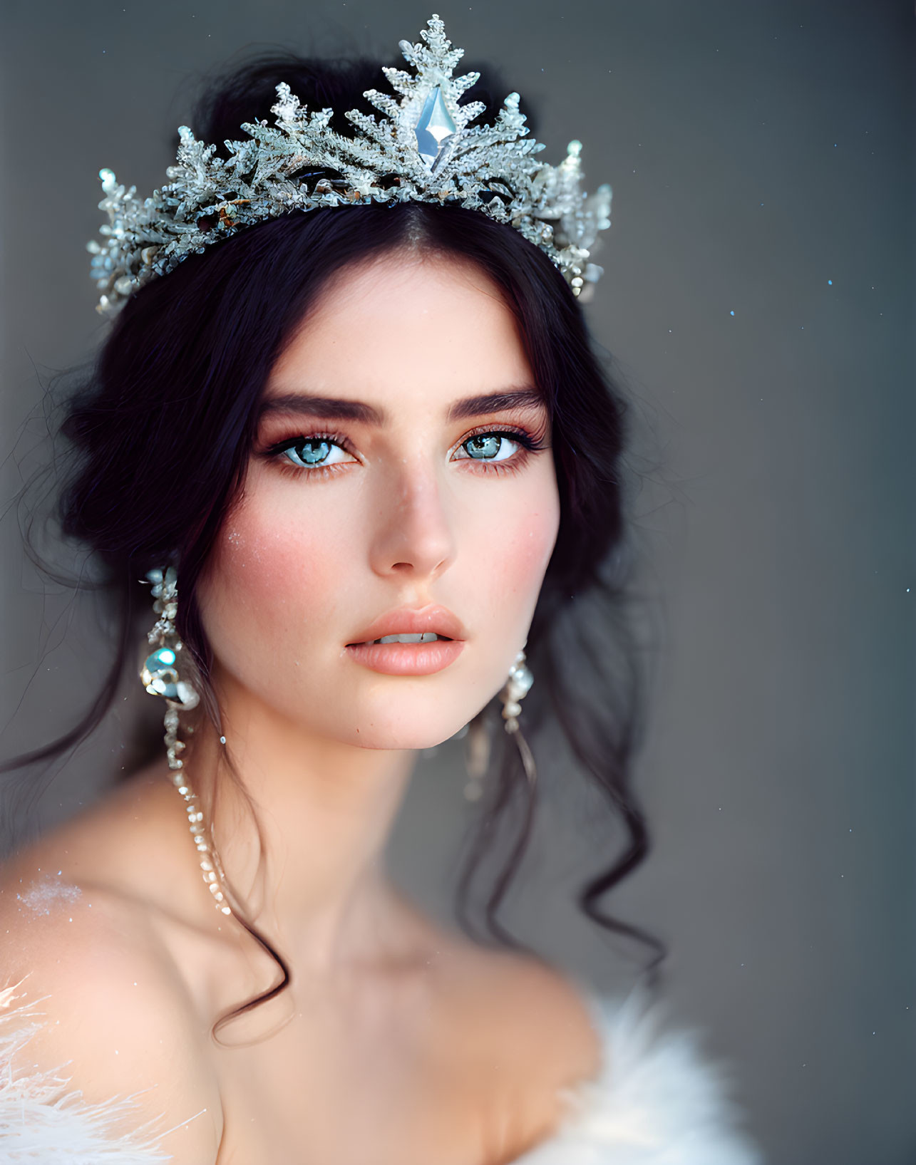 Woman with Blue Eyes in Snowflake Crown and Pearl Earrings on Grey Background