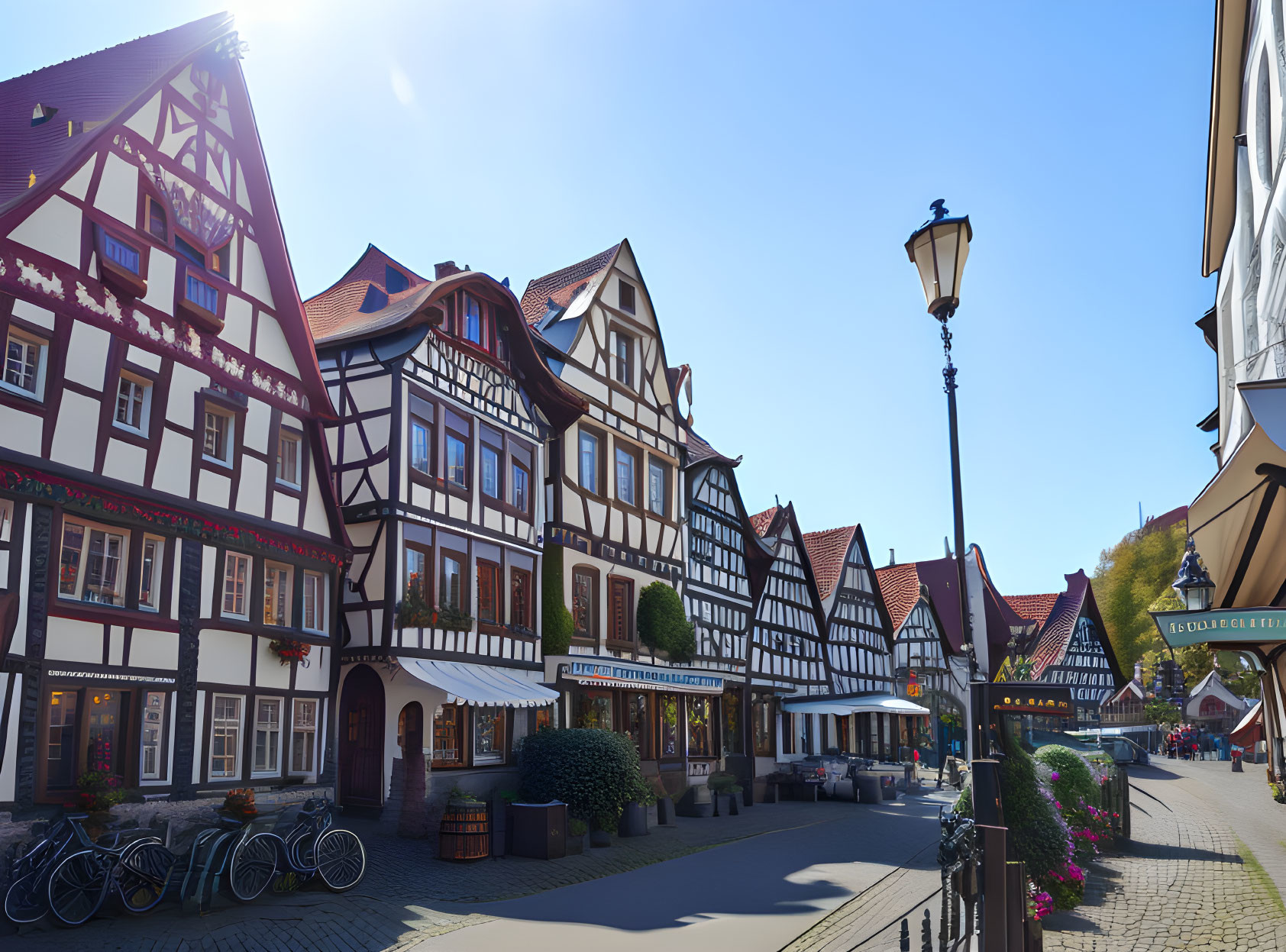 Half-timbered houses on cobblestone street in European village on sunny day