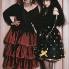 Gothic attire: Black corset, red skirt, leather coat characters