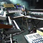 Futuristic electronic music equipment with keyboards and intricate machinery.