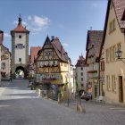 Charming cobblestone street with half-timbered houses and flowers