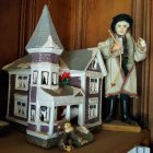 Snowy Christmas porch scene with Santa, person holding child, and happy dogs