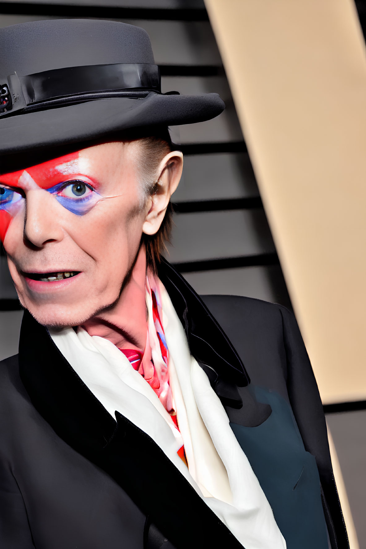 Vibrant blue and red face paint on figure in black suit and hat