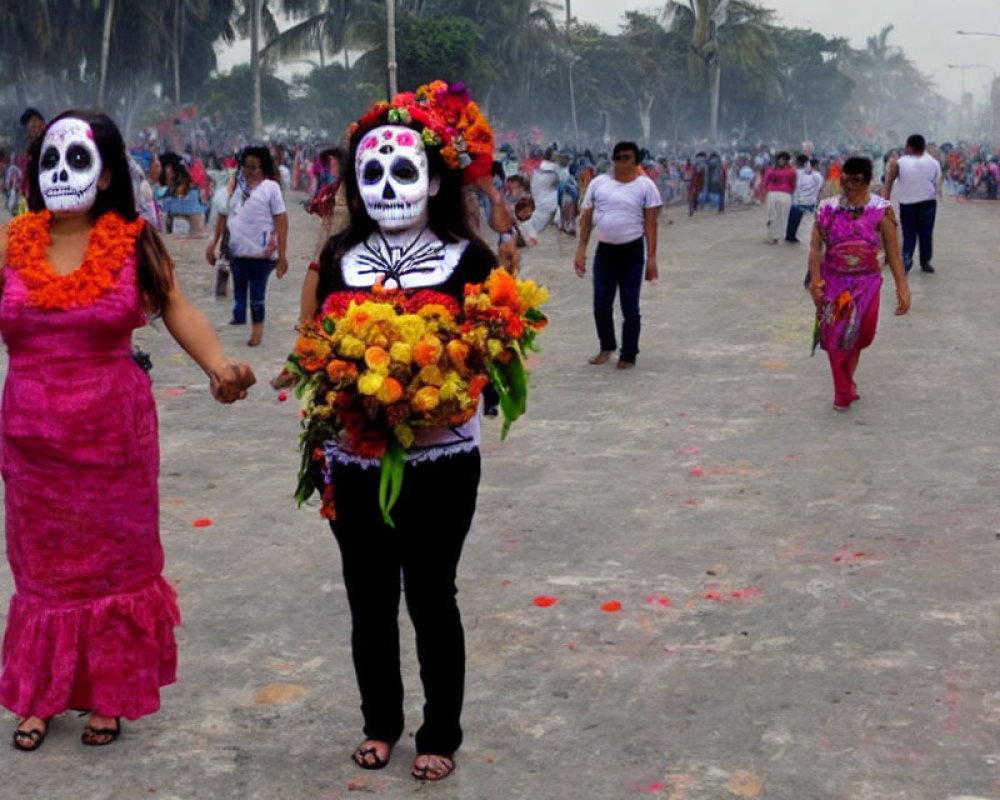 Skull-faced individuals with floral adornments in Day of the Dead celebration